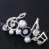 Musical notes - crystal brooch