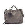 Vintage tas van nubuckleer met klinknagels / pom pom van bontTassen