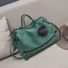 Vintage tas van nubuckleer met klinknagels / pom pom van bontTassen