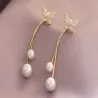 Lange gouden oorbellen - vlinder / parelsOorbellen