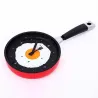Metal wall clock in the shape of a frying pan with a fried eggClocks